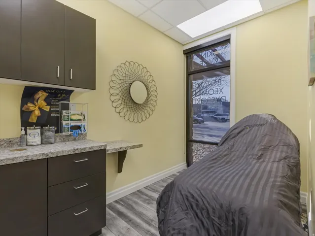 Bedroom with a drop ceiling and light wood-type flooring