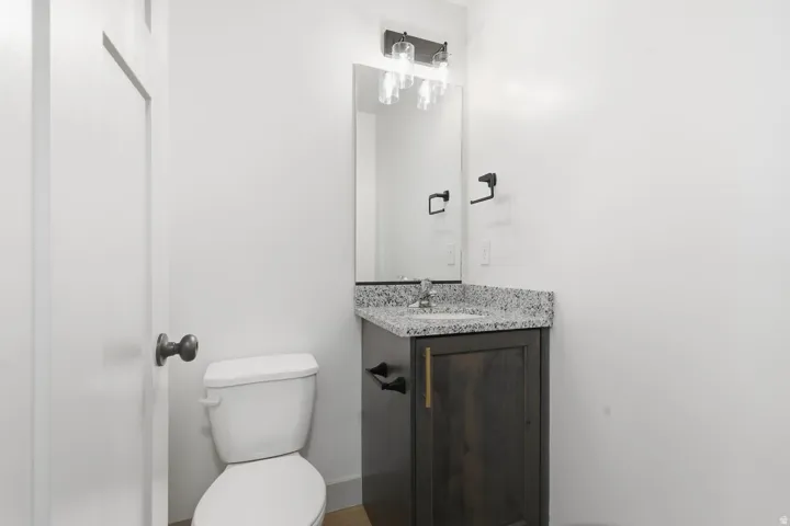 Half bathroom with vanity and toilet
