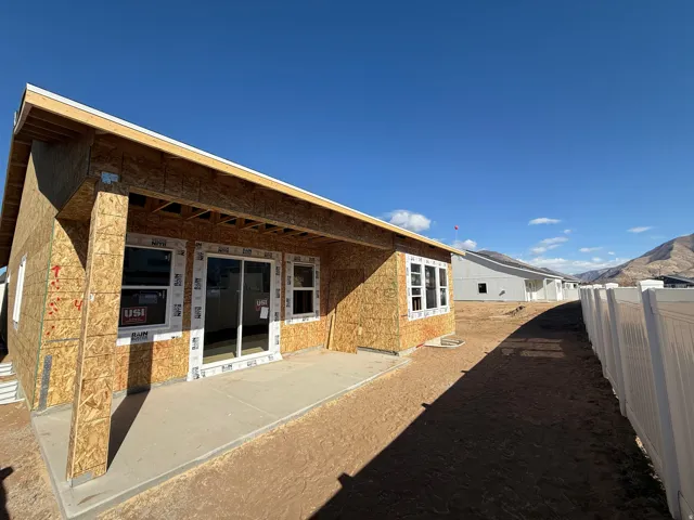 Rear view of house with a mountain view and a patio