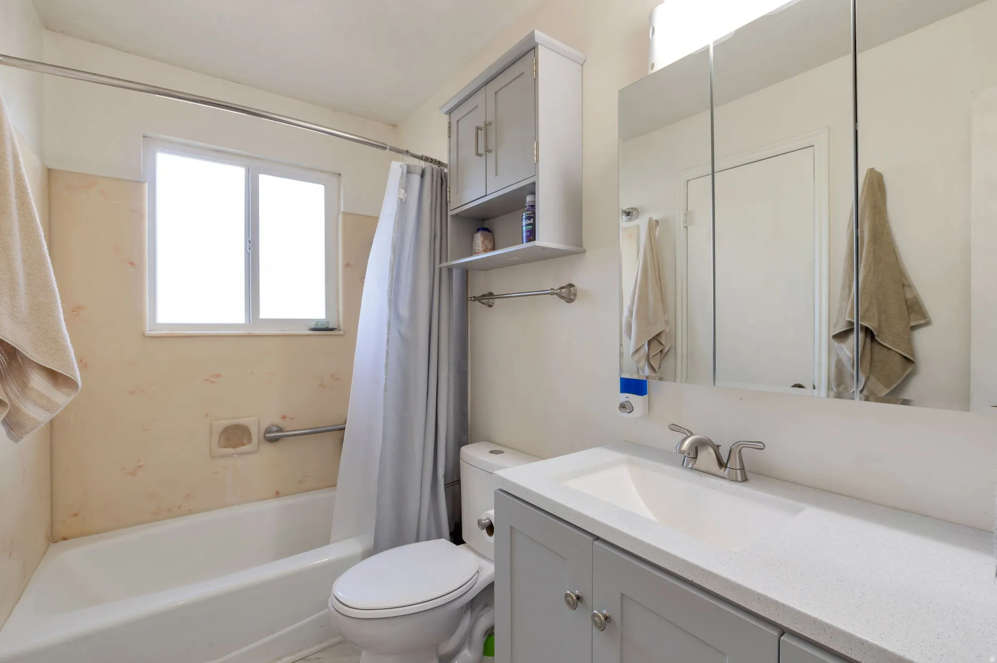 Bathroom with vanity and shower / bath combination with curtain