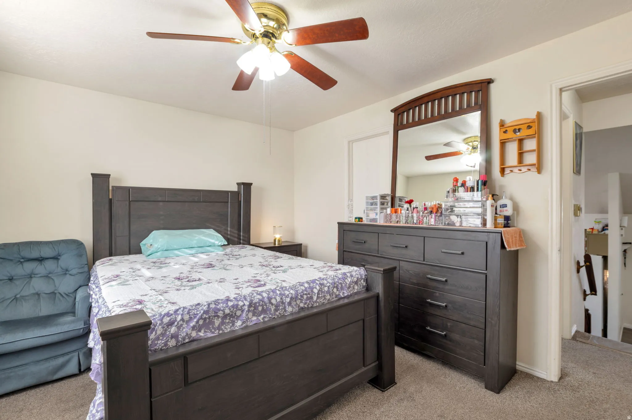 Bedroom featuring light colored carpet and a ceiling fan