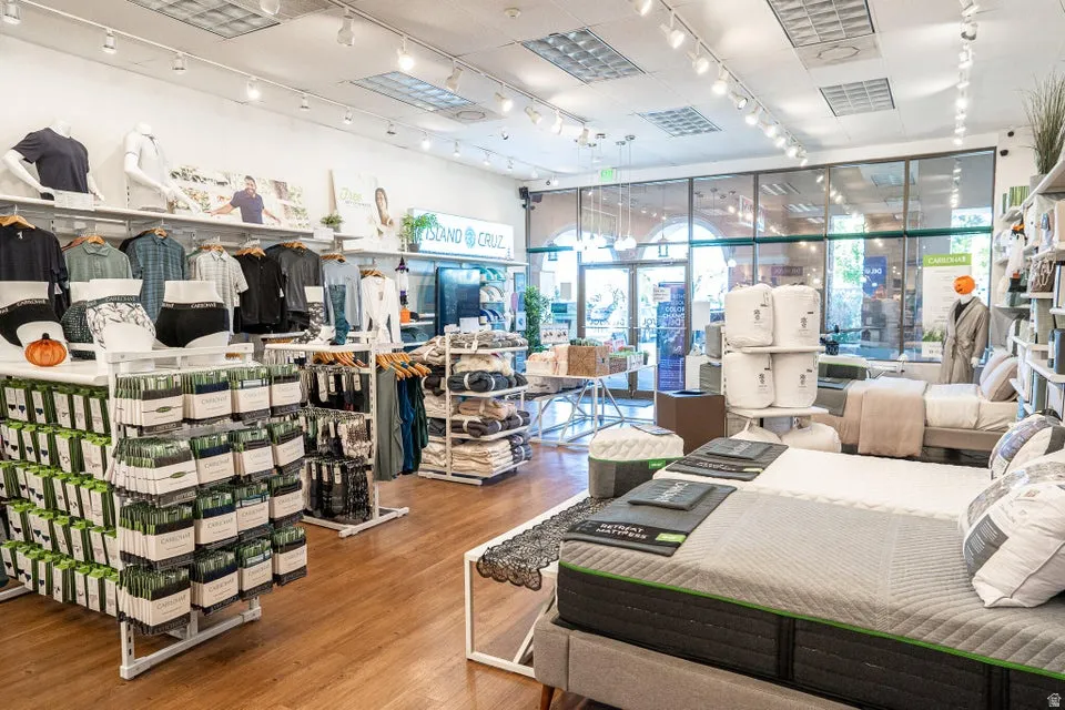 Bedroom with rail lighting and wood finished floors