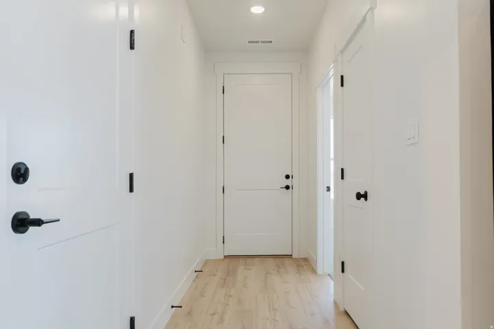 Hall featuring light wood-type flooring and recessed lighting