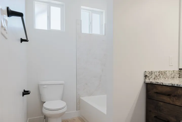 Full bathroom featuring vanity, bathtub / shower combination, and light wood finished floors