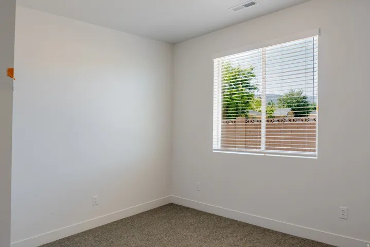 Unfurnished room featuring baseboards and carpet