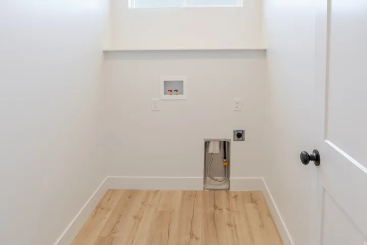Laundry area featuring wood finished floors, washer hookup, and hookup for an electric dryer