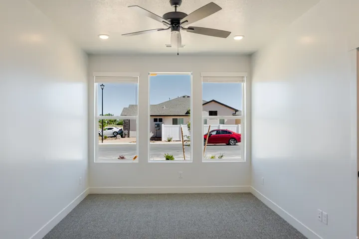 Spare room featuring light carpet, a ceiling fan, a textured ceiling, and recessed lighting