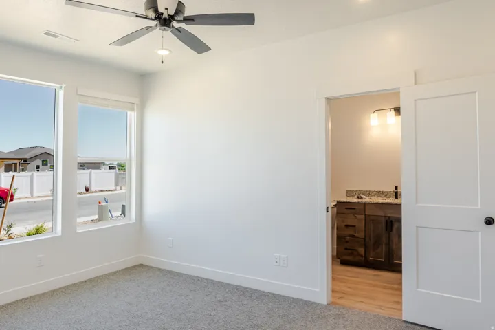 Spare room featuring ceiling fan and light carpet