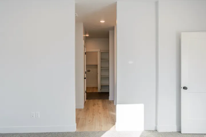Hallway featuring light wood-style floors and recessed lighting