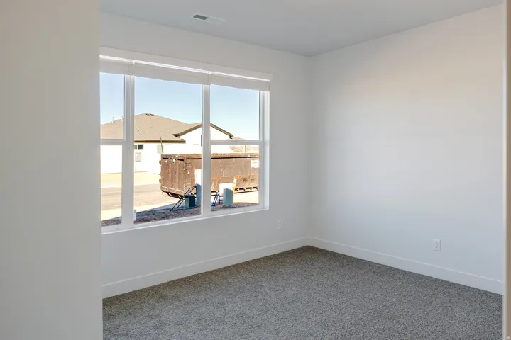 Unfurnished room with baseboards and carpet