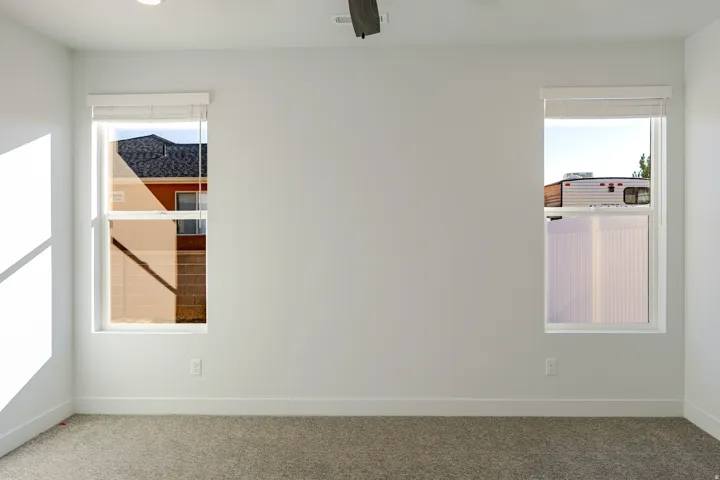 Carpeted empty room featuring baseboards