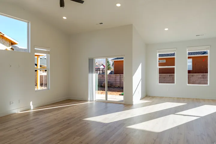 Spare room featuring lofted ceiling, recessed lighting, light wood-type flooring, and a ceiling fan