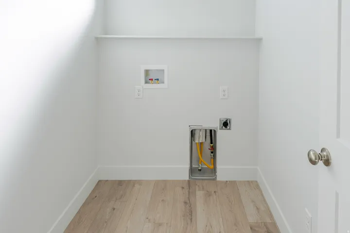 Laundry room with wood finished floors, washer hookup, and electric dryer hookup