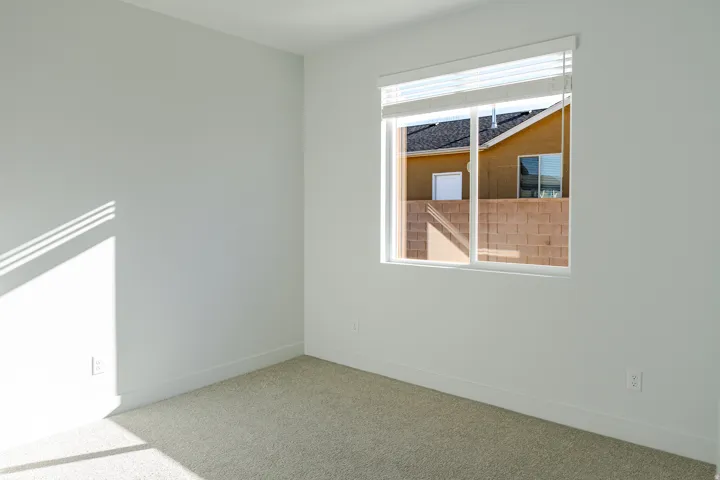 Unfurnished room with carpet floors and baseboards