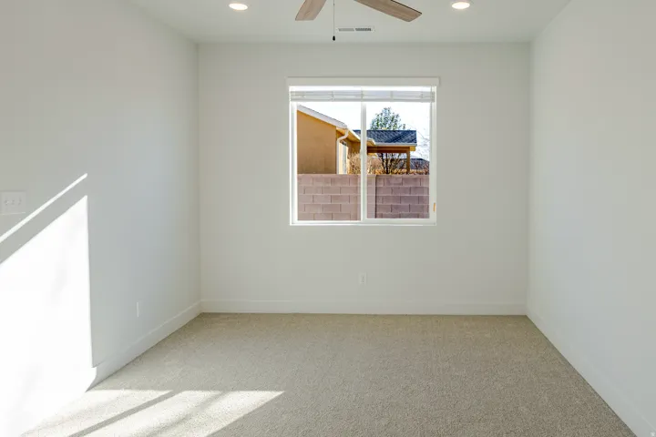 Spare room with light carpet, a ceiling fan, and recessed lighting