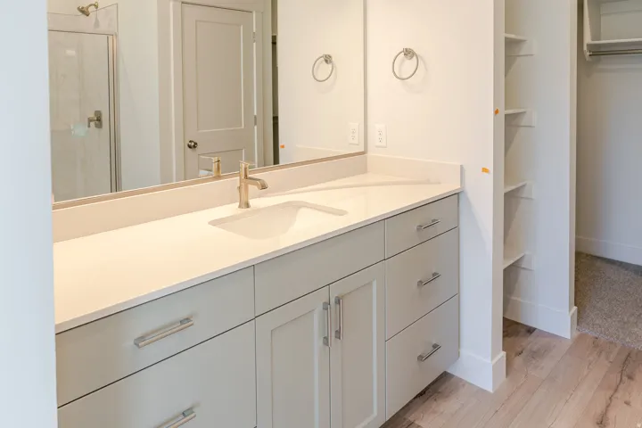 Full bathroom with vanity, a shower stall, and light wood finished floors
