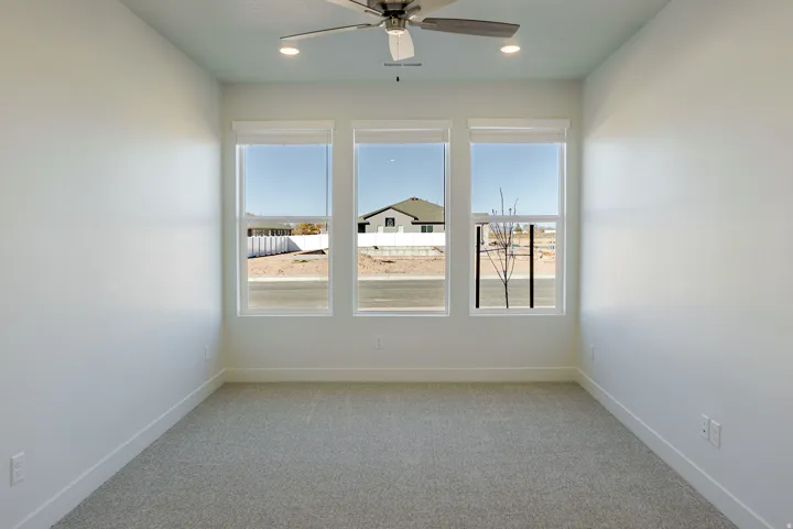 Empty room with light carpet, ceiling fan, and recessed lighting