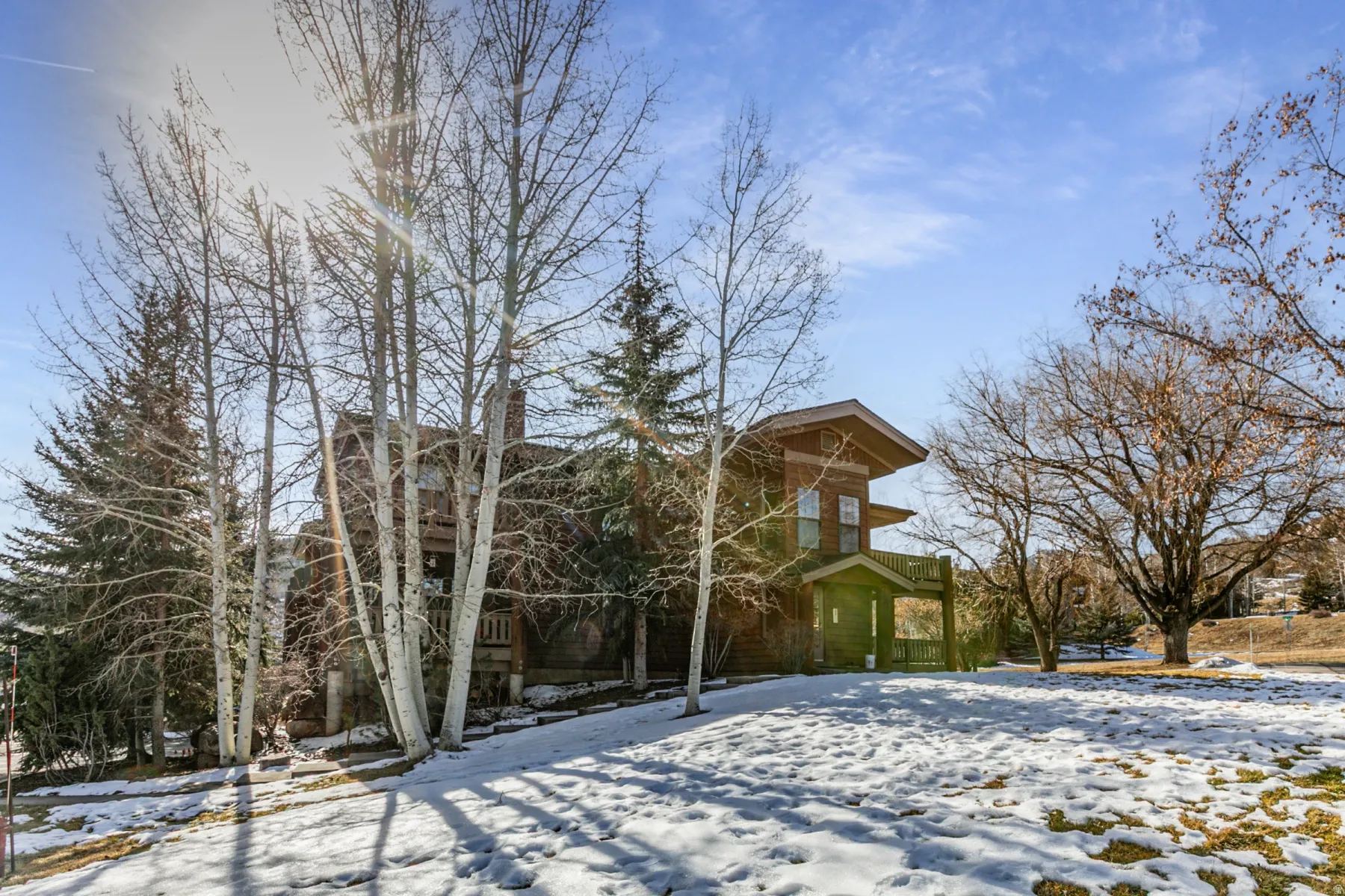 Snow covered property with a chimney