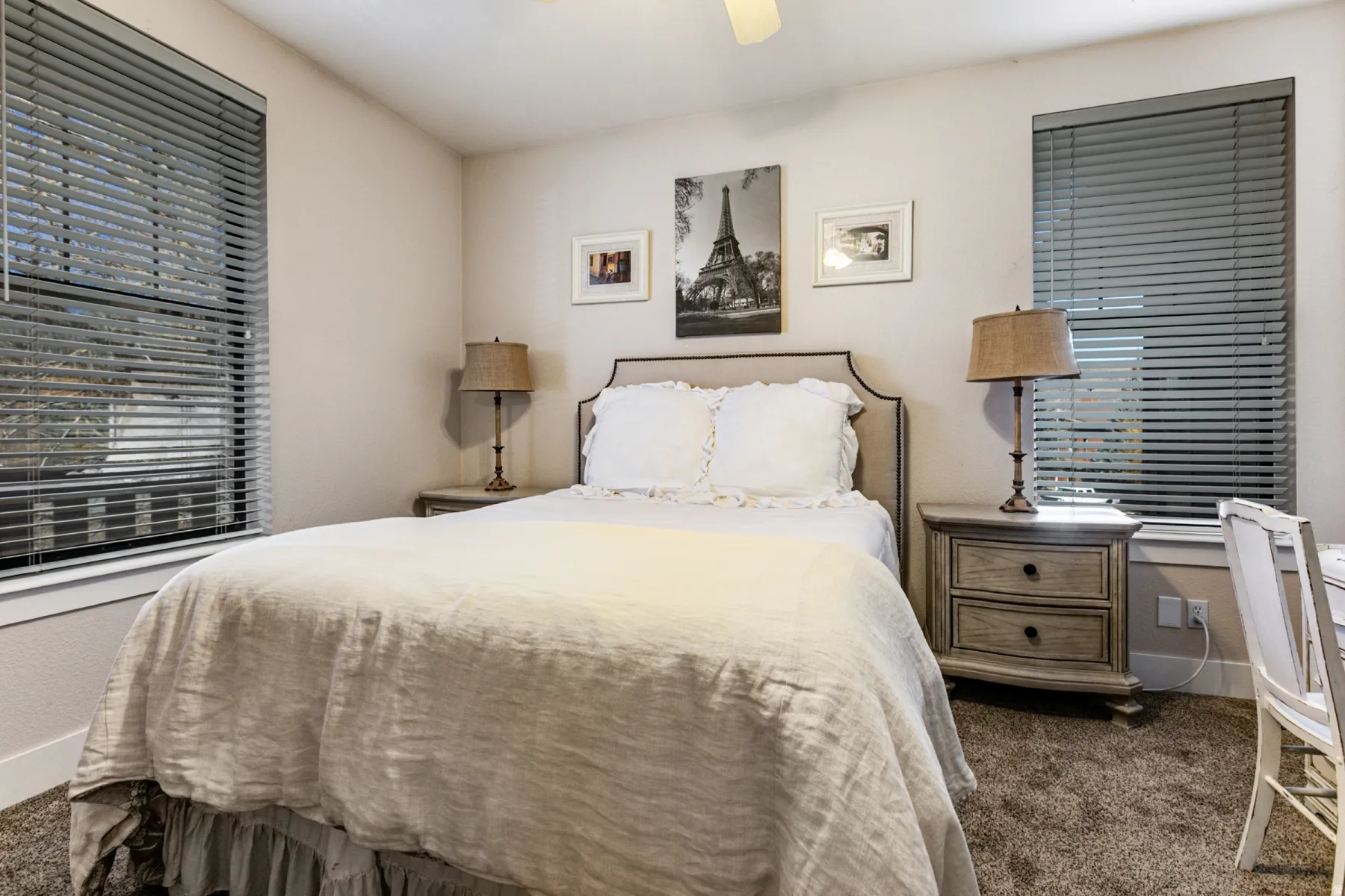 Bedroom with dark carpet and ceiling fan