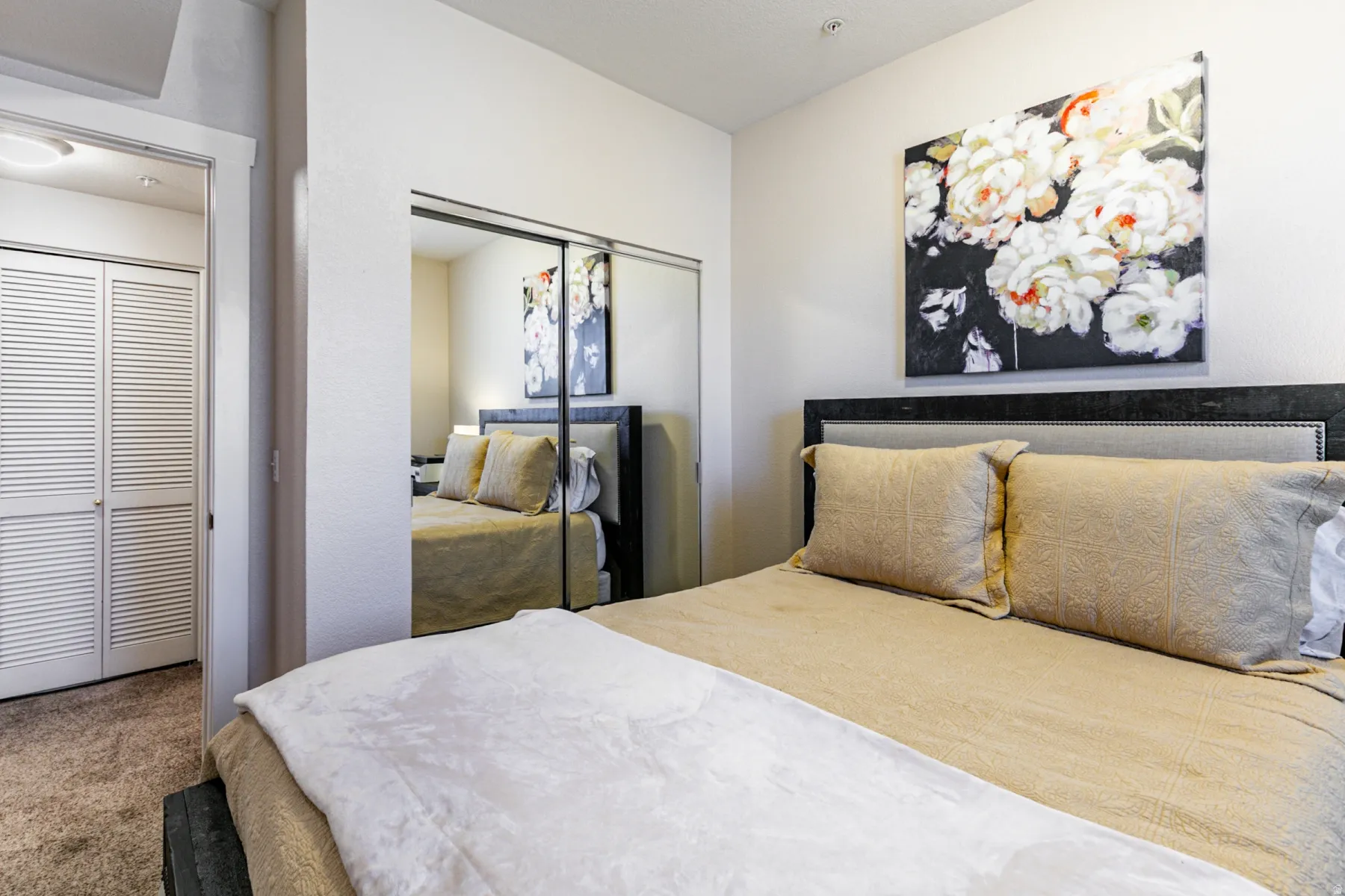 Carpeted bedroom with a closet