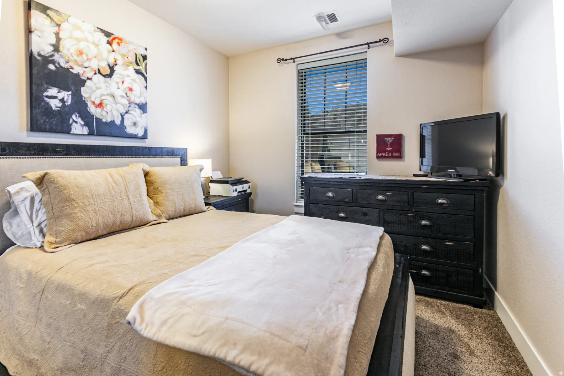 Bedroom featuring dark colored carpet and baseboards