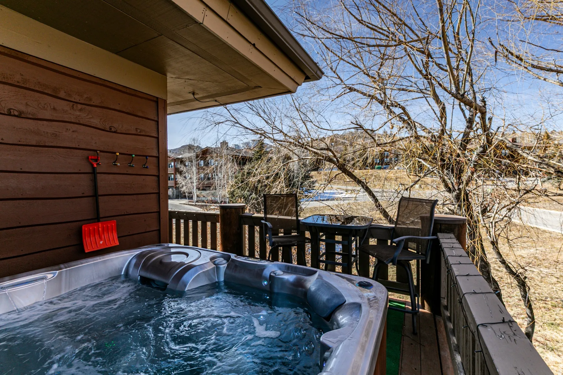 Wooden terrace featuring a hot tub