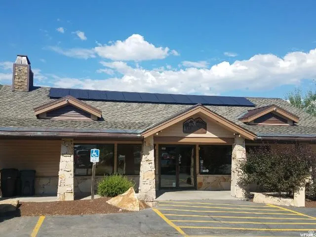 View of building exterior featuring uncovered parking