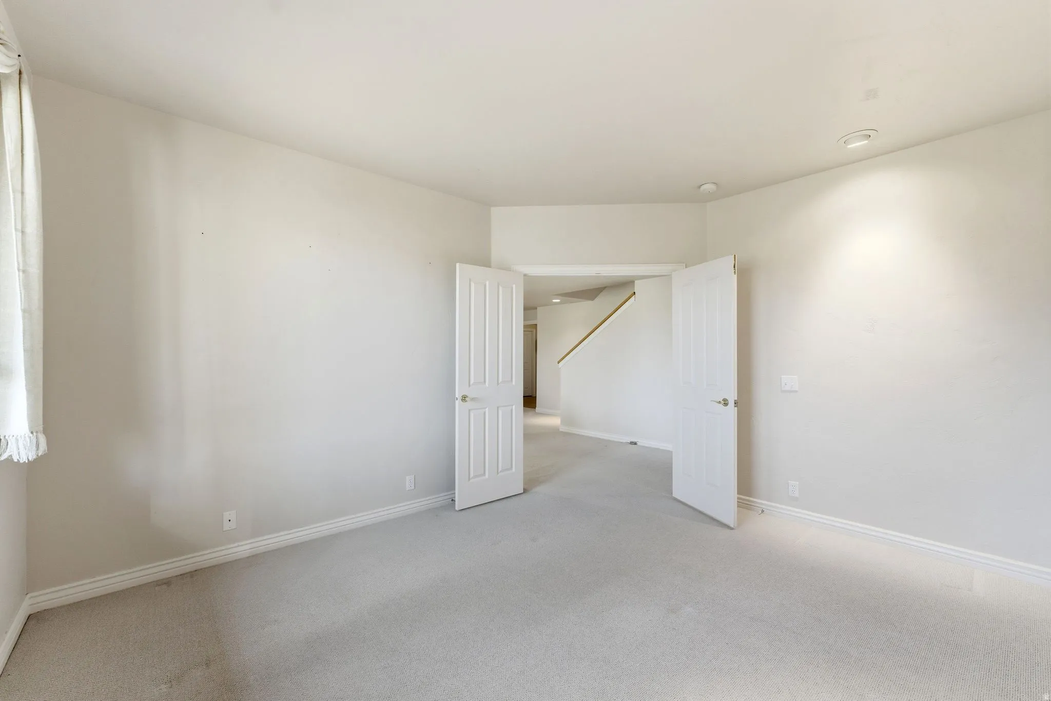 Carpeted empty room featuring baseboards