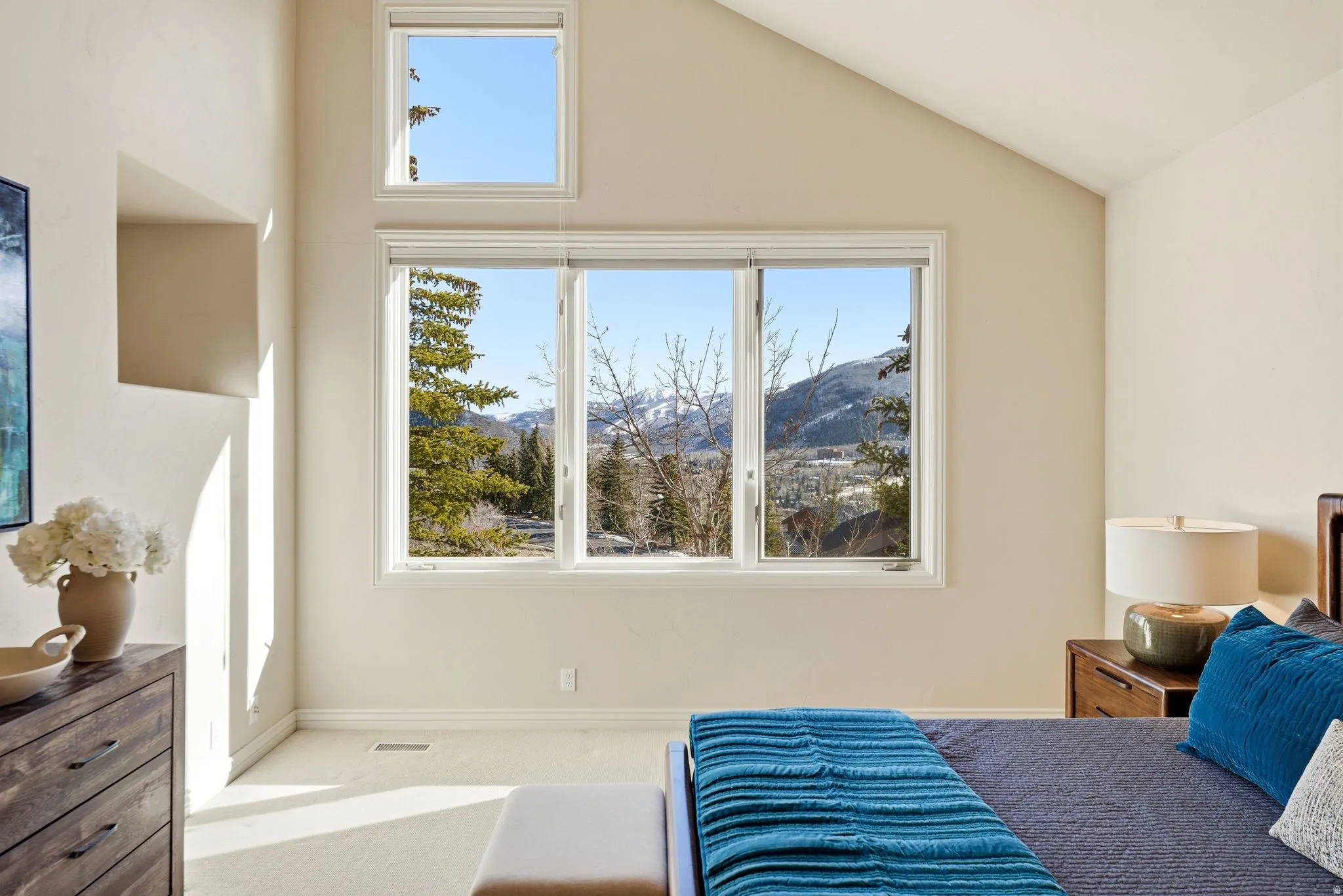 Carpeted bedroom featuring a mountain view and lofted ceiling