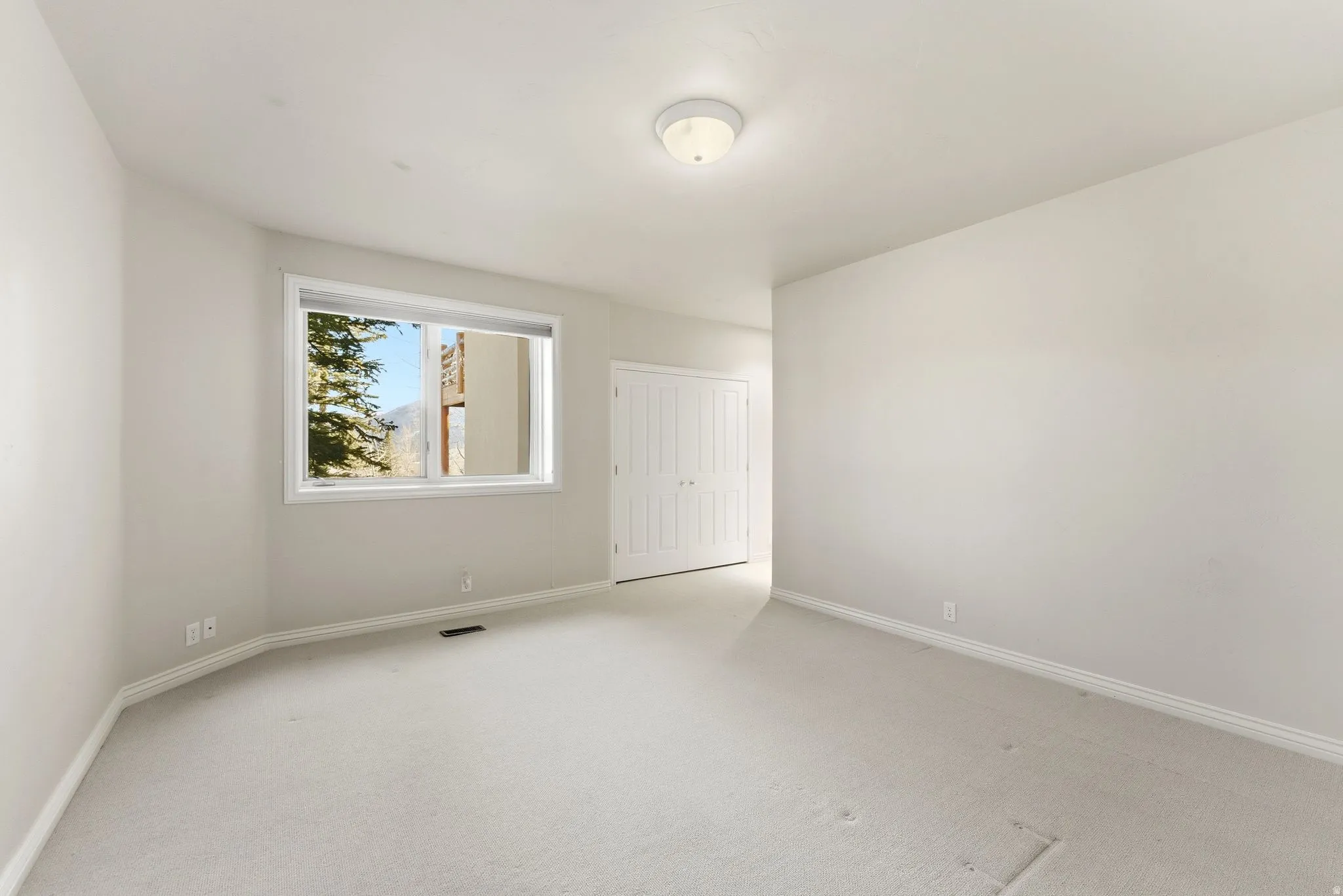 Unfurnished bedroom with carpet and a closet
