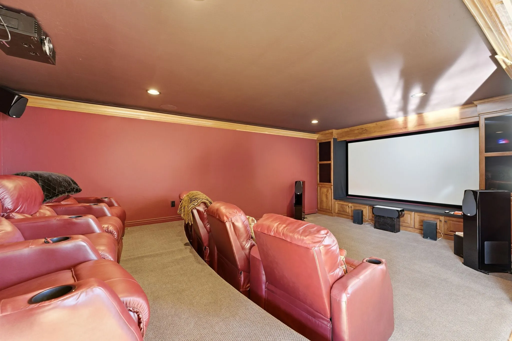 Cinema with light carpet, crown molding, and recessed lighting