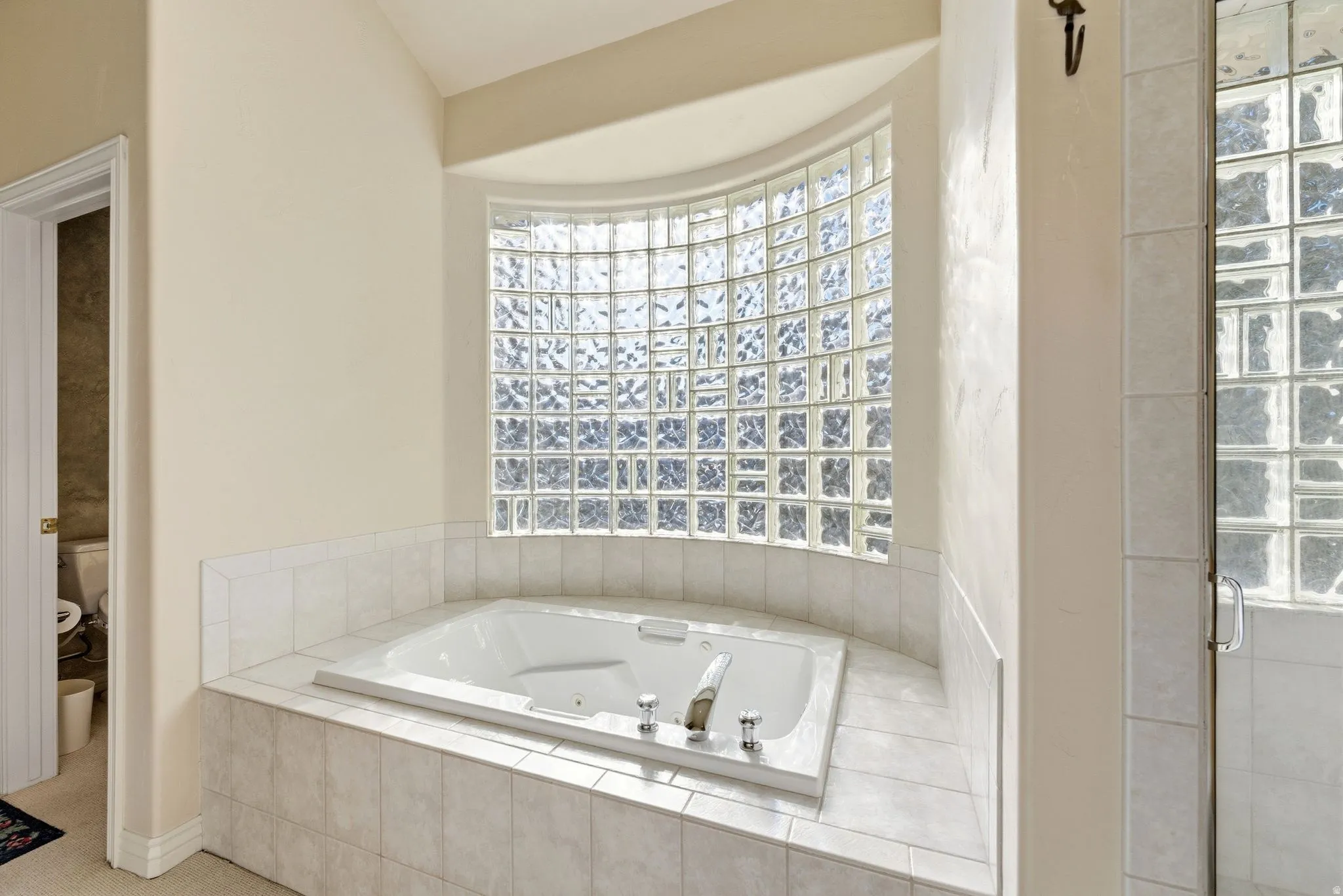 Bathroom with a whirlpool tub and plenty of natural light