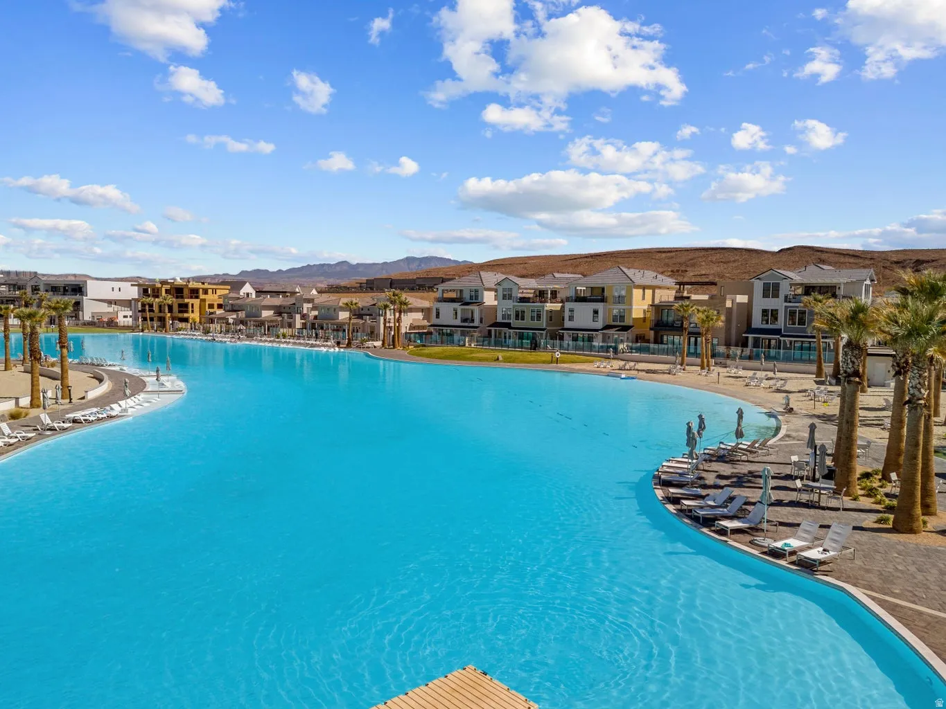 Community pool with a patio and a residential view