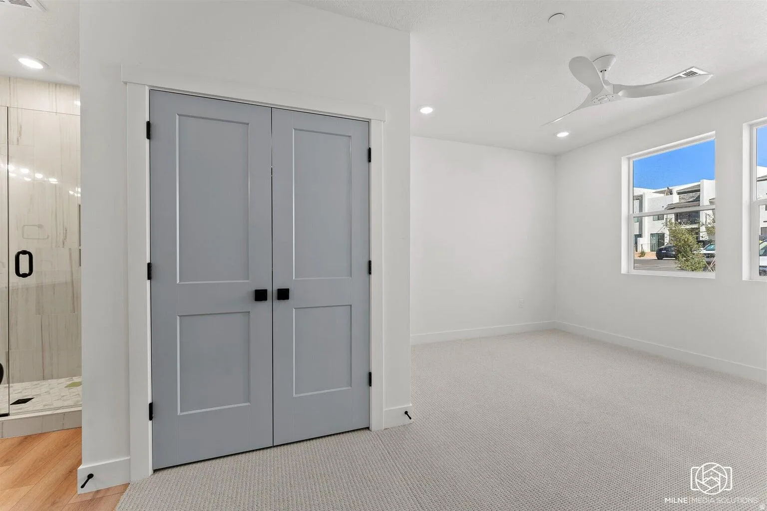 Unfurnished bedroom with a closet, recessed lighting, light carpet, and a ceiling fan