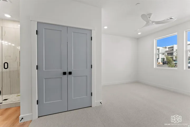 Unfurnished bedroom with a closet, recessed lighting, light carpet, and a ceiling fan