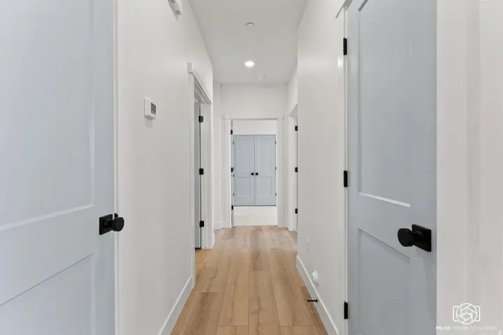 Hall featuring light wood finished floors and recessed lighting