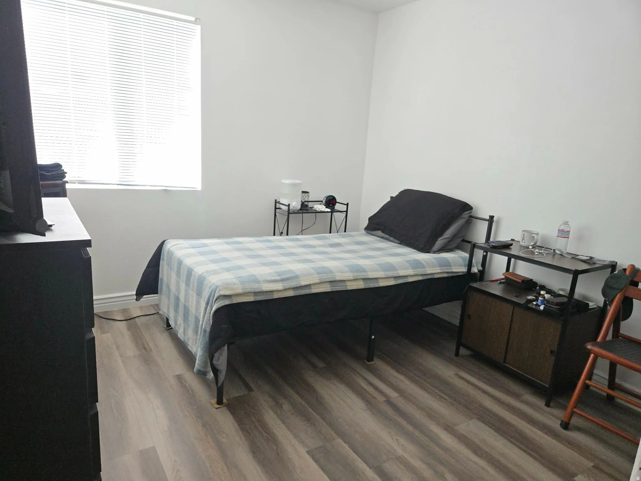 Bedroom with light wood-style flooring and baseboards