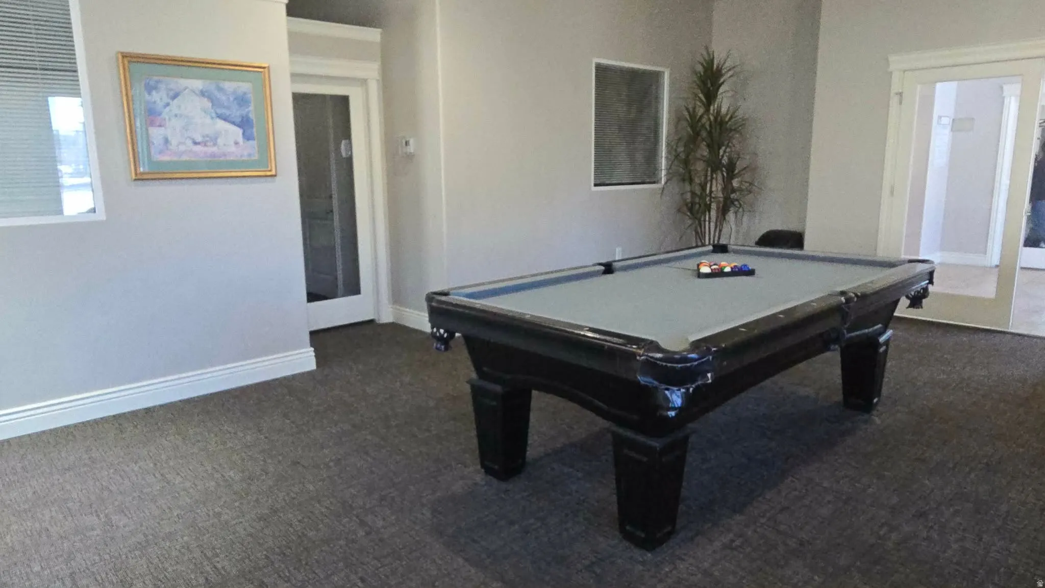 Game room with dark carpet and billiards table