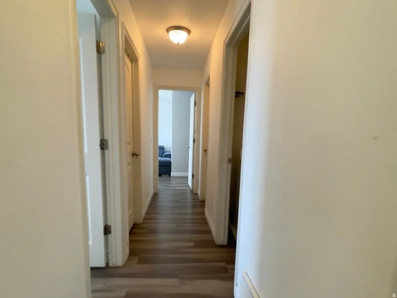 Hall featuring wood finished floors and baseboards