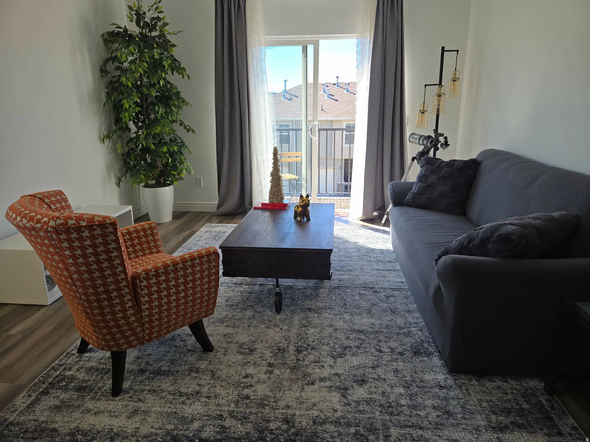 Living area with wood finished floors and baseboards