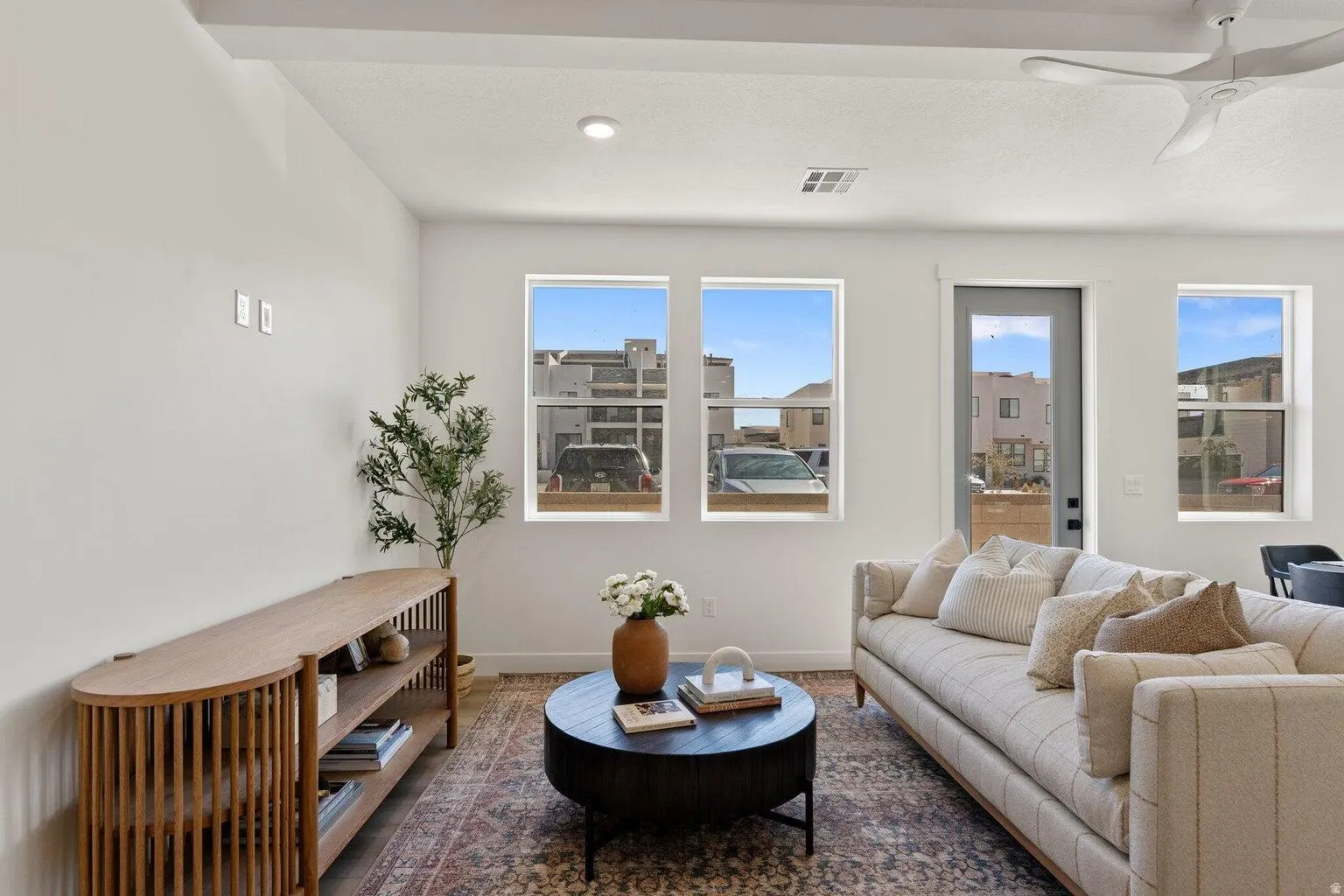 Living room featuring ceiling fan and baseboards