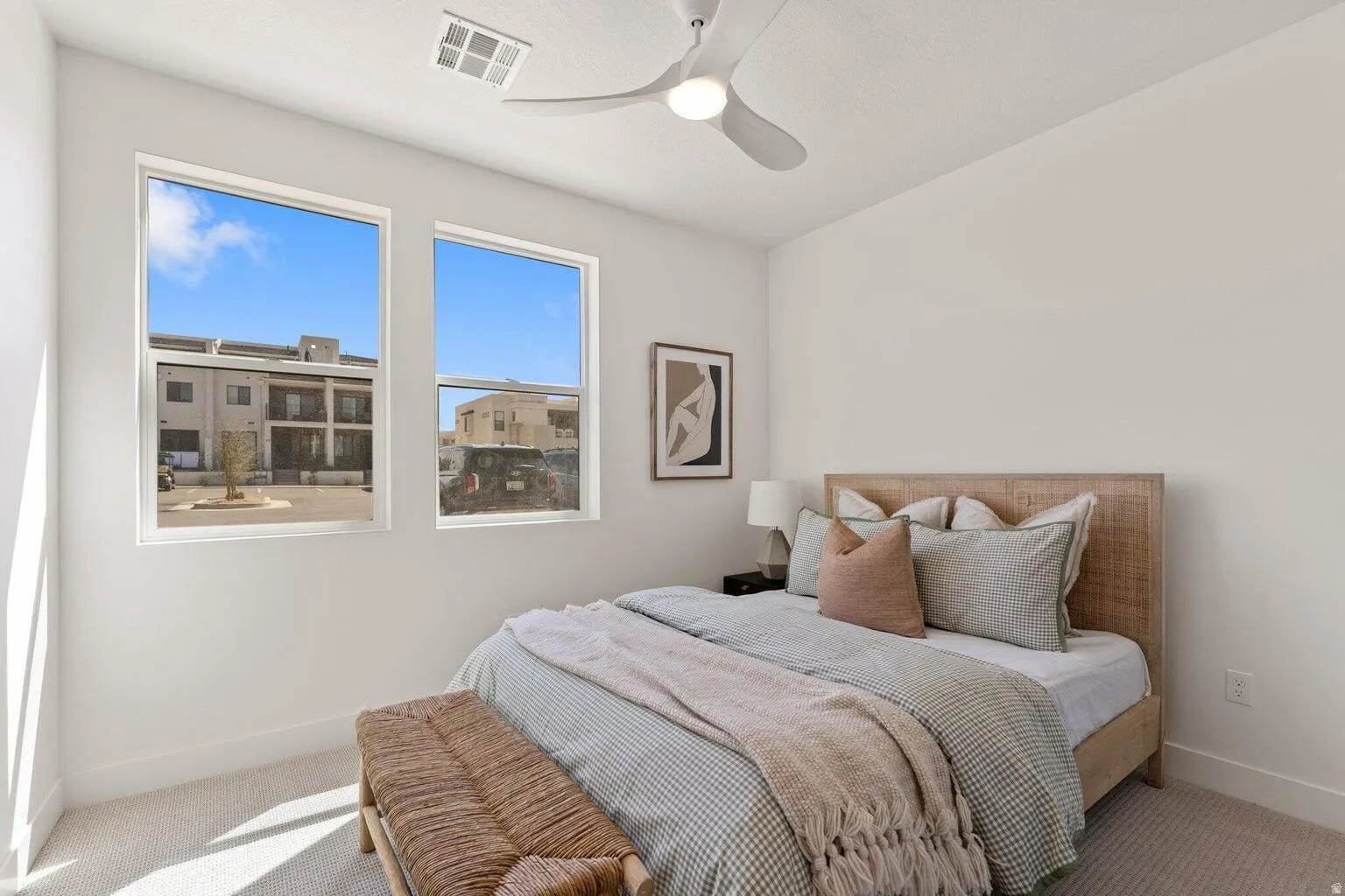Carpeted bedroom featuring baseboards and a ceiling fan