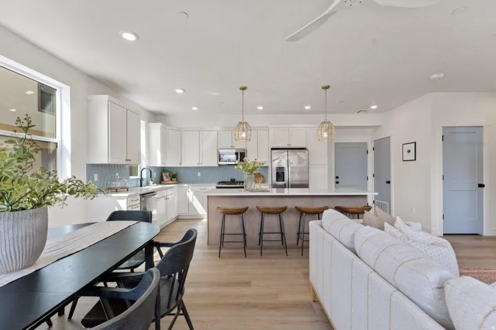 Dining area with light wood-type flooring, ceiling fan, and recessed lighting