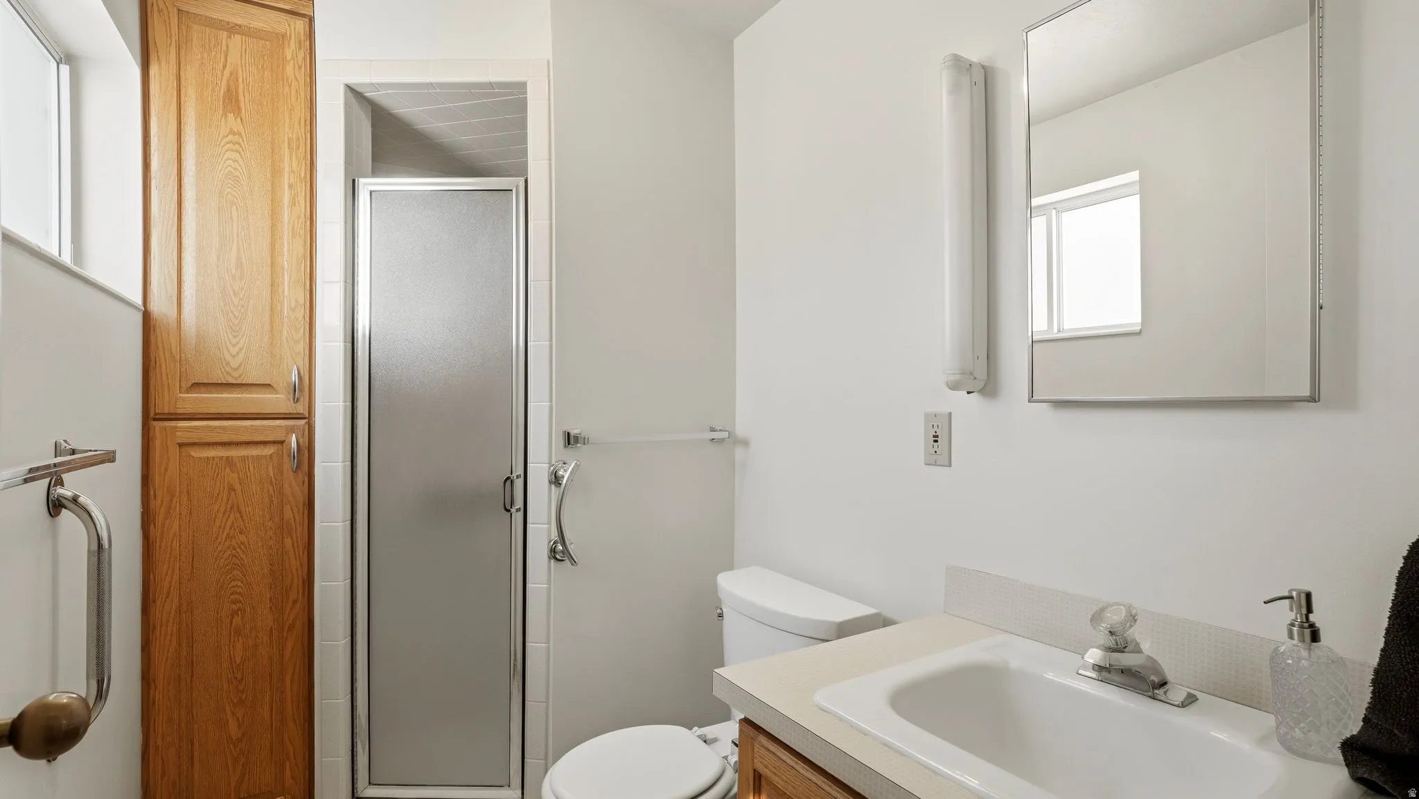 Full bath with a stall shower and vanity