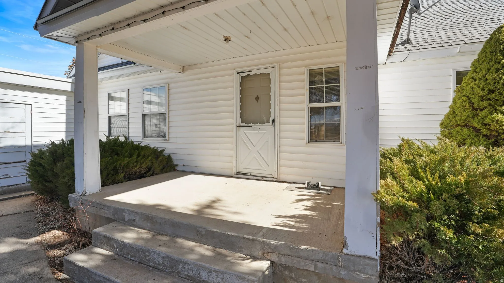 Entrance to property featuring covered porch