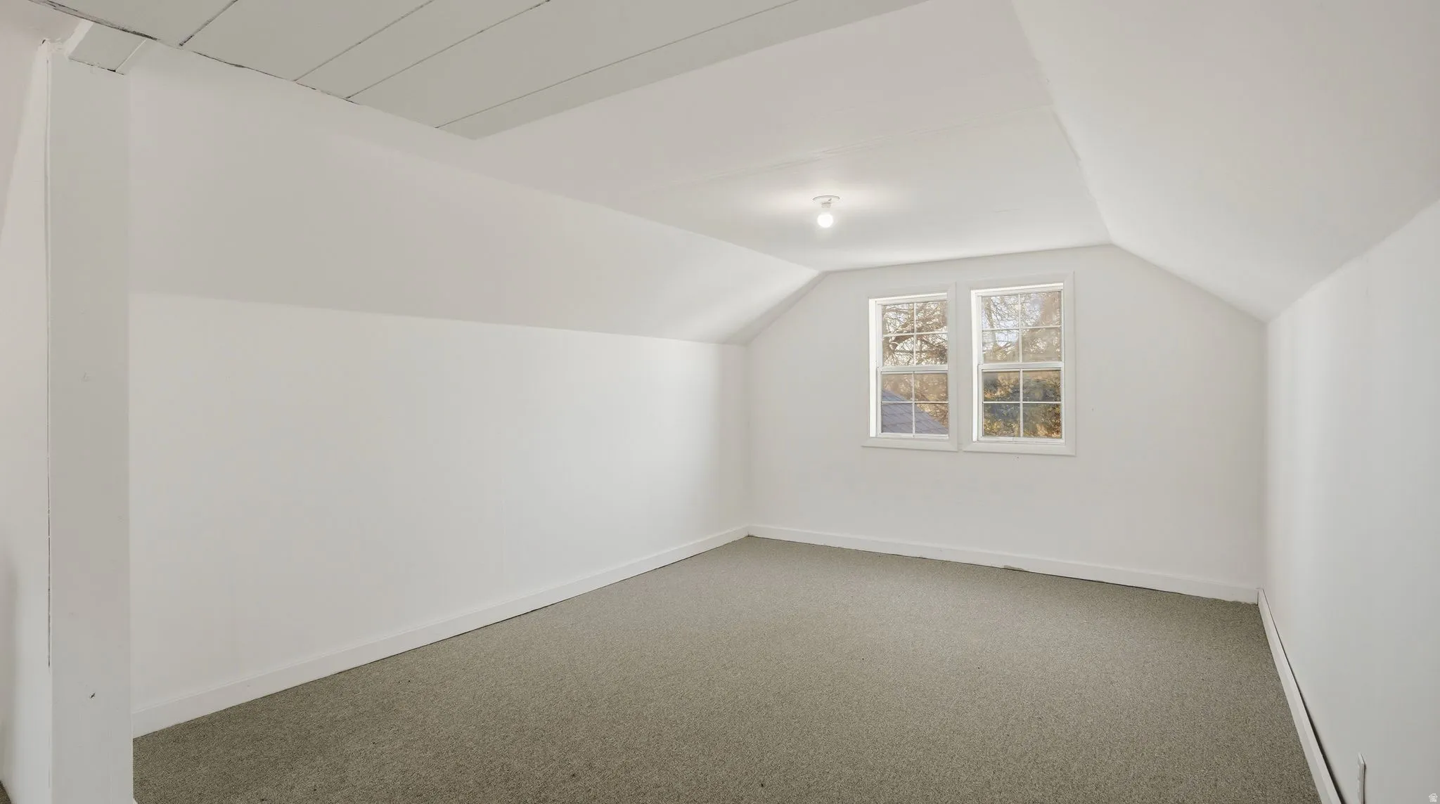 Bonus room featuring carpet and baseboards