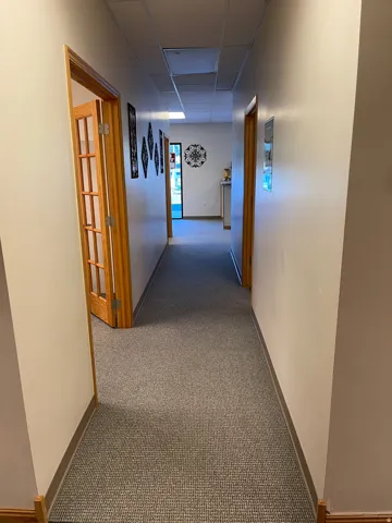 Hall featuring carpet and a drop ceiling