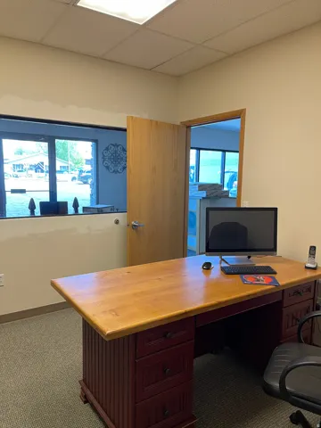 Home office featuring carpet flooring and a paneled ceiling