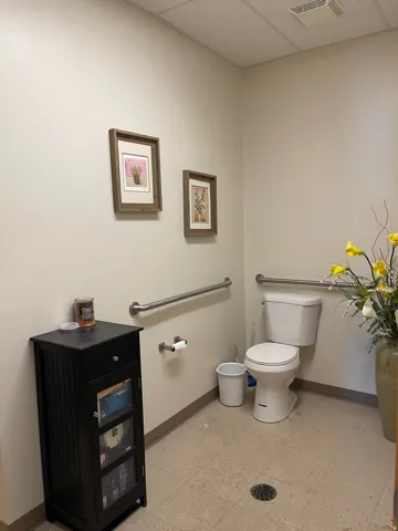 Bathroom featuring a paneled ceiling and light flooring
