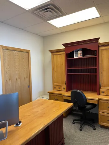 Office space featuring built in study area and a paneled ceiling